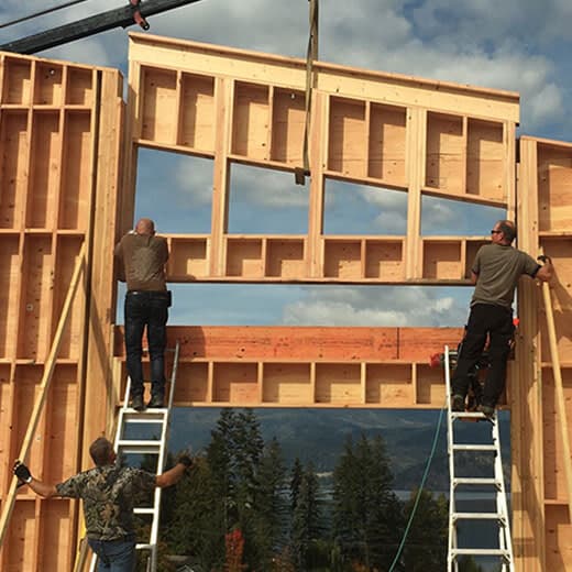 Crew lifting a prefabricated wall panel